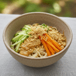 Cold noodles with peanut sauce served with fresh toppings